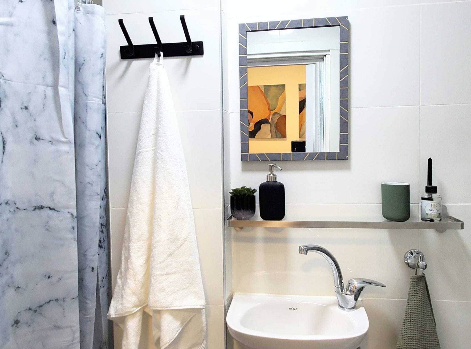 Bright white bathroom with fresh towels and toiletries
